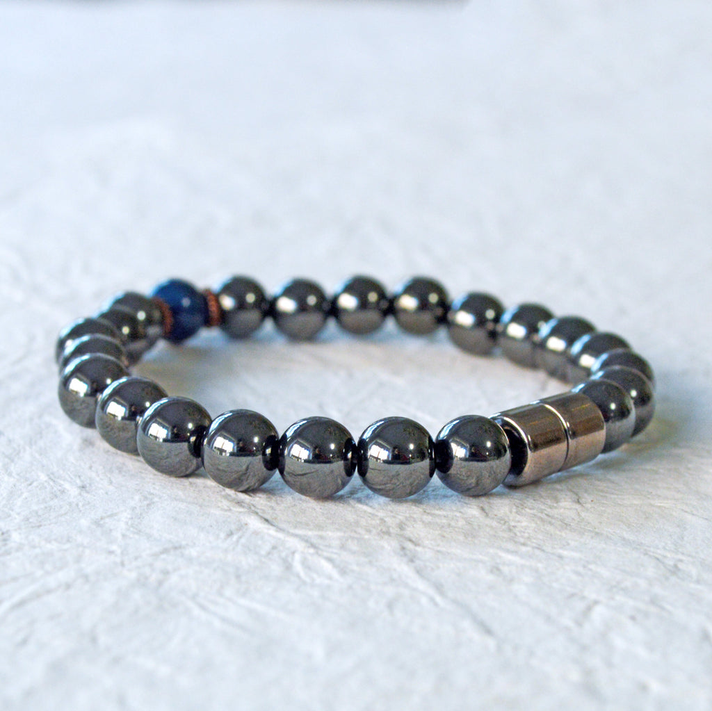 Magnetic Bracelet handcrafted with powerful black magnetic hematite beads and a center blue riverstone bead. Secured with a strong and easy-to-use magnetic clasp.