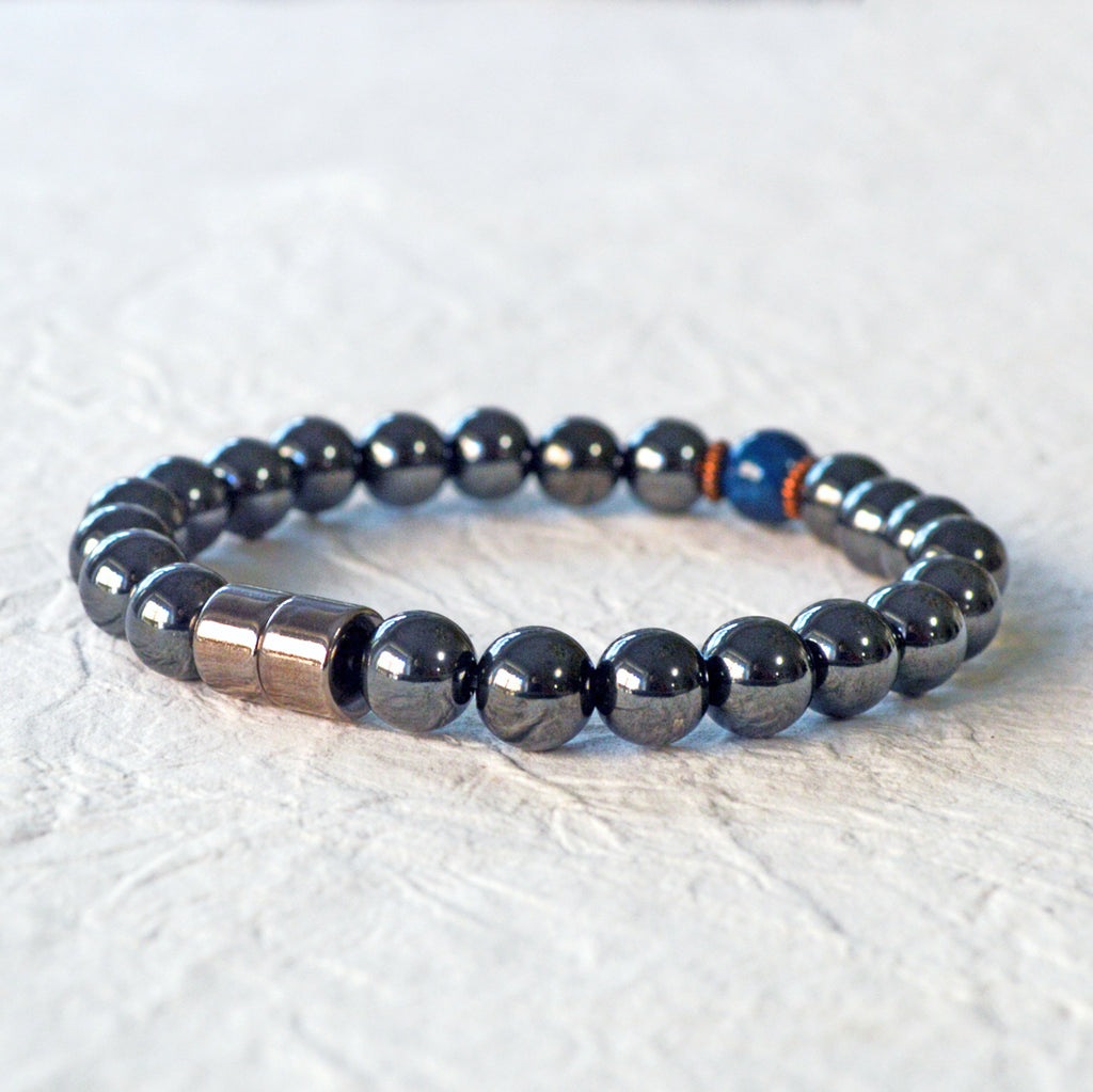 Magnetic Bracelet handcrafted with powerful black magnetic hematite beads and a center blue riverstone bead. Secured with a strong and easy-to-use magnetic clasp.