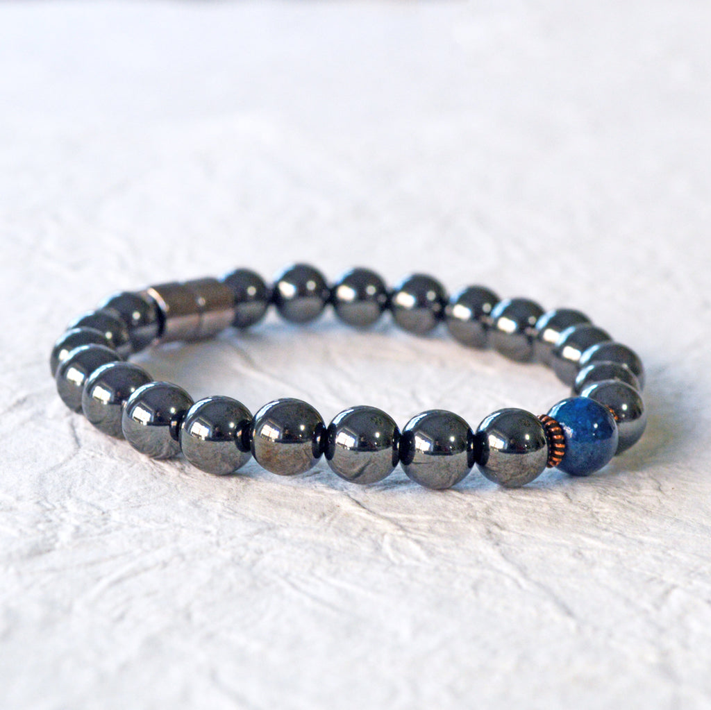 Magnetic Bracelet handcrafted with powerful black magnetic hematite beads and a center blue riverstone bead. Secured with a strong and easy-to-use magnetic clasp.
