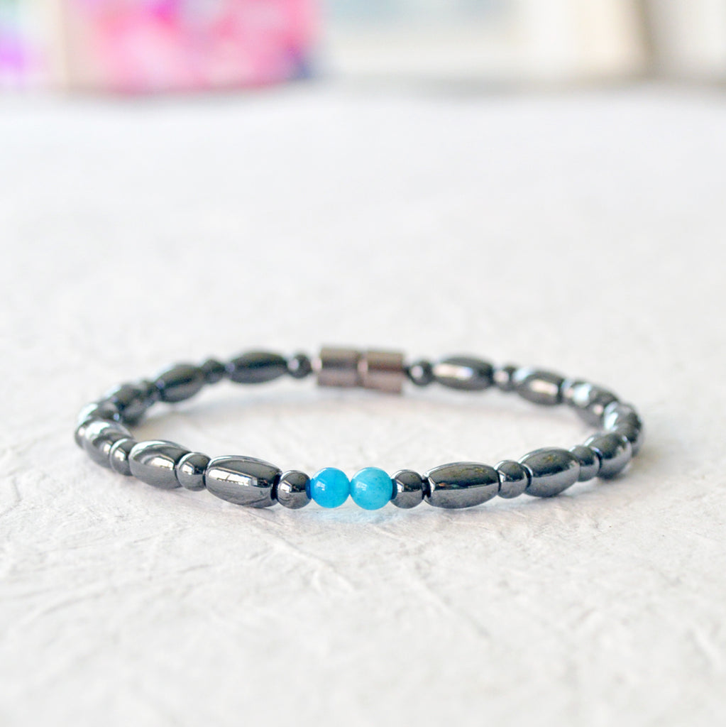 Magnetic bracelet for women handcrafted with black hematite magnetic beads with two blue magnesite beads in the center. Bracelet secured with a strong magnetic clasp.