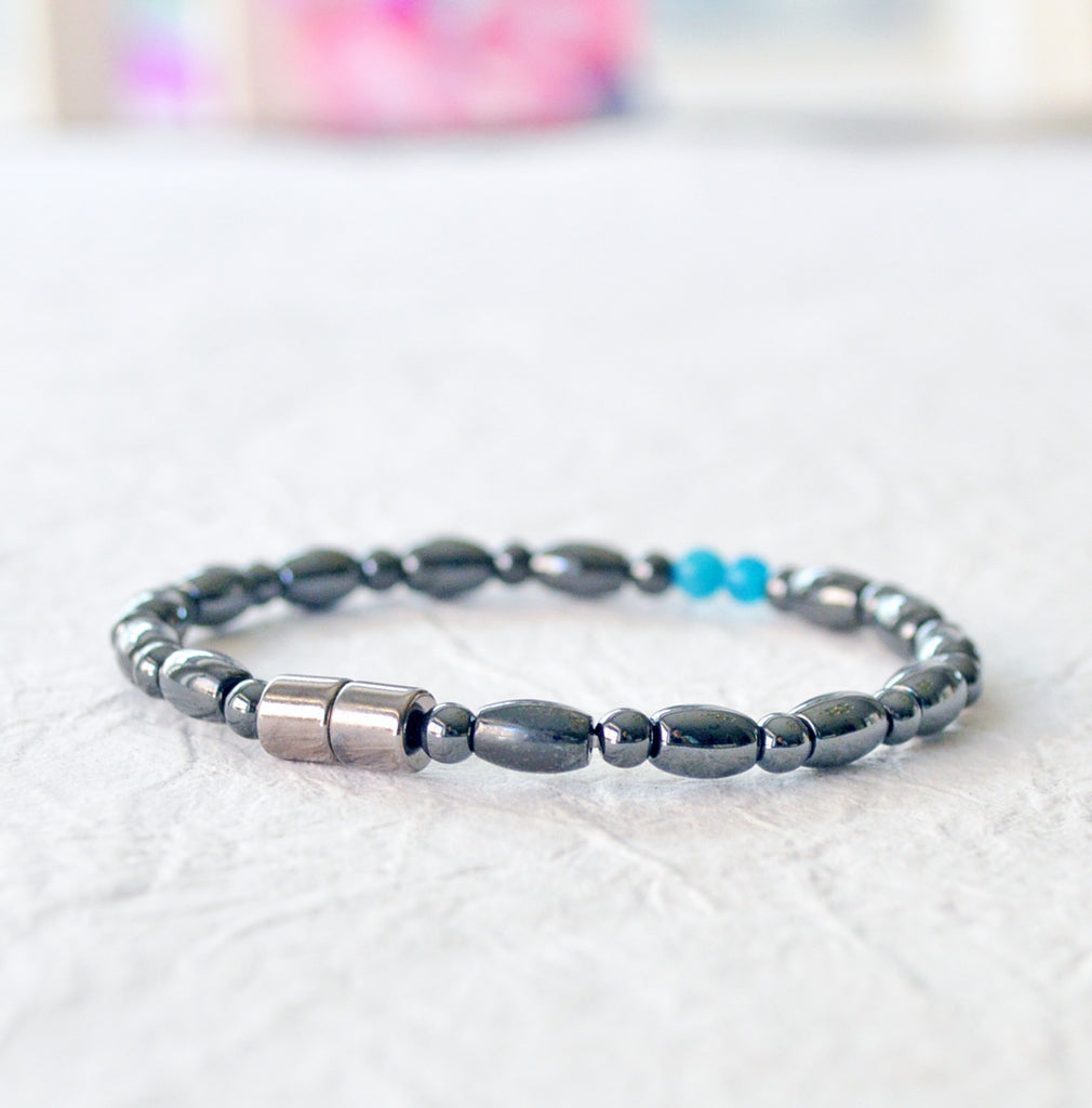 Magnetic bracelet for women handcrafted with black hematite magnetic beads with two blue magnesite beads in the center. Bracelet secured with a strong magnetic clasp.