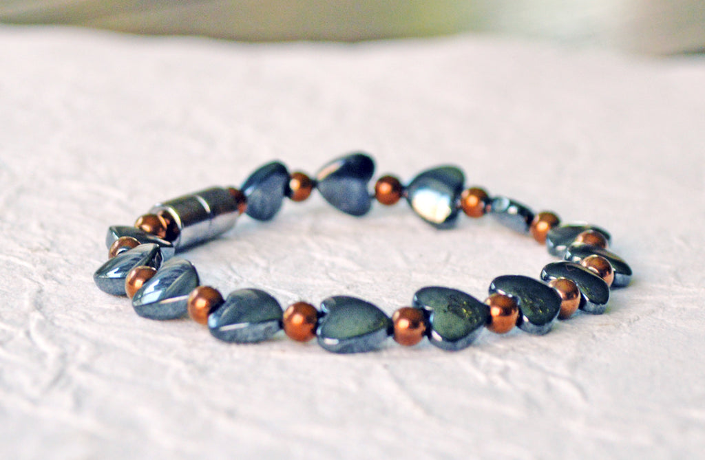 Magnetic heart bracelet for women handcrafted with alternating black hematite magnetic heart beads and copper metallic hematite magnetic beads. Bracelet secured with a strong and easy-to-use magnetic clasp.