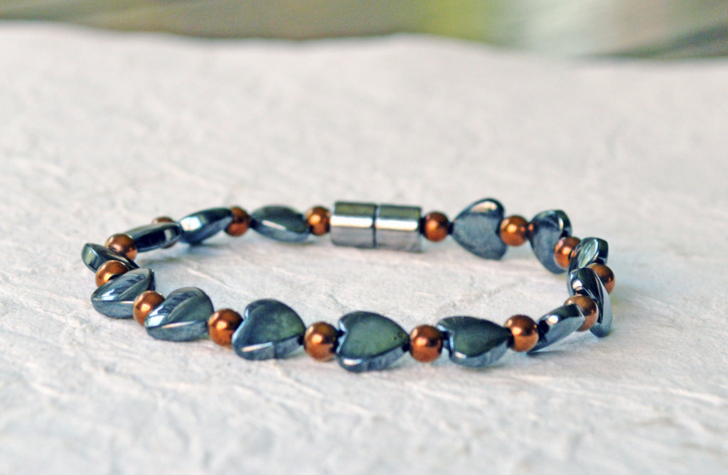 Magnetic heart bracelet for women handcrafted with alternating black hematite magnetic heart beads and copper metallic hematite magnetic beads. Bracelet secured with a strong and easy-to-use magnetic clasp.