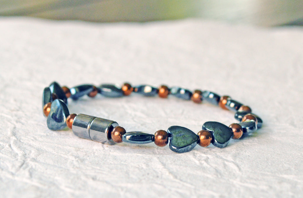 Magnetic heart bracelet for women handcrafted with alternating black hematite magnetic heart beads and copper metallic hematite magnetic beads. Bracelet secured with a strong and easy-to-use magnetic clasp.