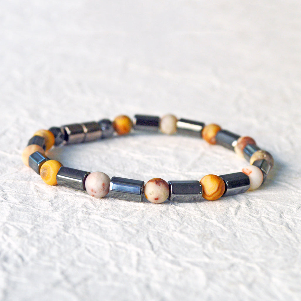 Magnetic hematite bracelet handcrafted with  black magnetic hematite bead and frosted agate gemstone bead. Secured with a strong magnetic clasp.