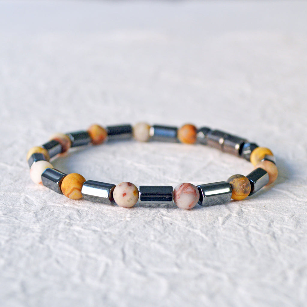 Magnetic hematite bracelet handcrafted with  black magnetic hematite bead and frosted agate gemstone bead. Secured with a strong magnetic clasp.