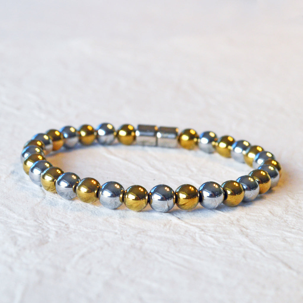 Magnetic bracelet handcrafted with alternating gold and silver metallic magnetic beads. Secured with a strong and easy-to-use magnetic clasp.