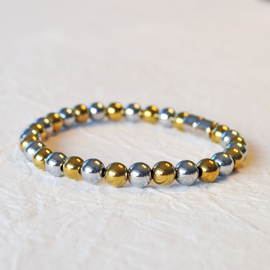 Magnetic bracelet handcrafted with alternating gold and silver metallic magnetic beads. Secured with a strong and easy-to-use magnetic clasp.