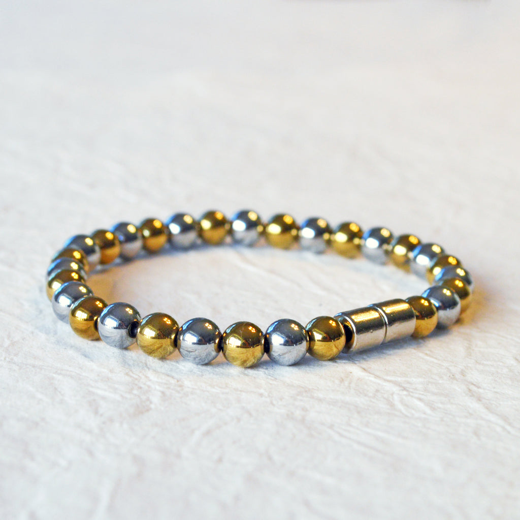 Magnetic bracelet handcrafted with alternating gold and silver metallic magnetic beads. Secured with a strong and easy-to-use magnetic clasp.