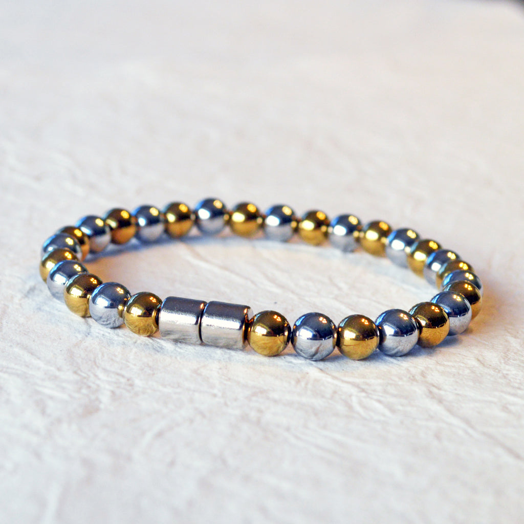 Magnetic bracelet handcrafted with alternating gold and silver metallic magnetic beads. Secured with a strong and easy-to-use magnetic clasp.