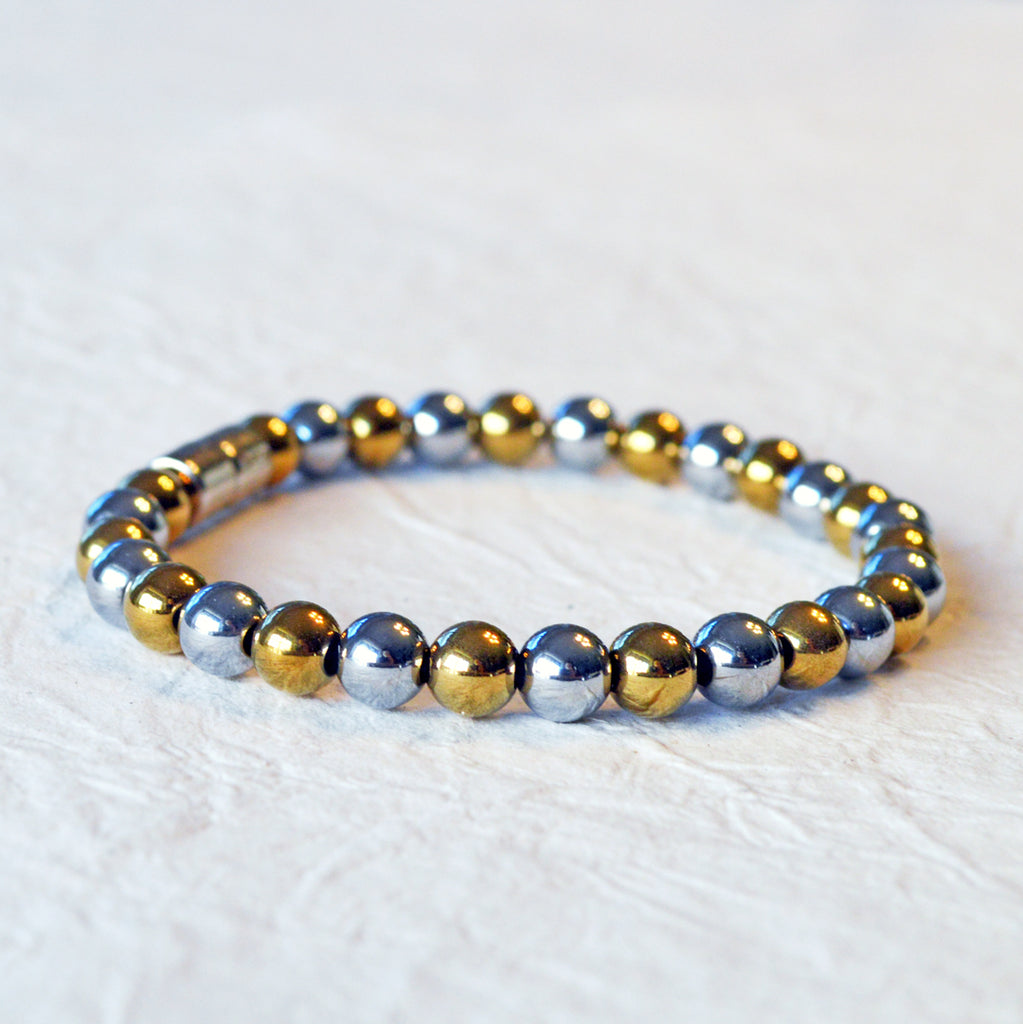 Magnetic bracelet handcrafted with alternating gold and silver metallic magnetic beads. Secured with a strong and easy-to-use magnetic clasp.