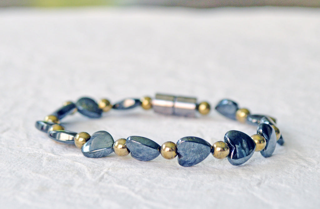 Magnetic bracelet for women handcrafted with alternating black hematite heart magnetic beads and gold metallic hematite magnetic beads. Bracelet is secured with a strong and easy-to-use magnetic clasp.