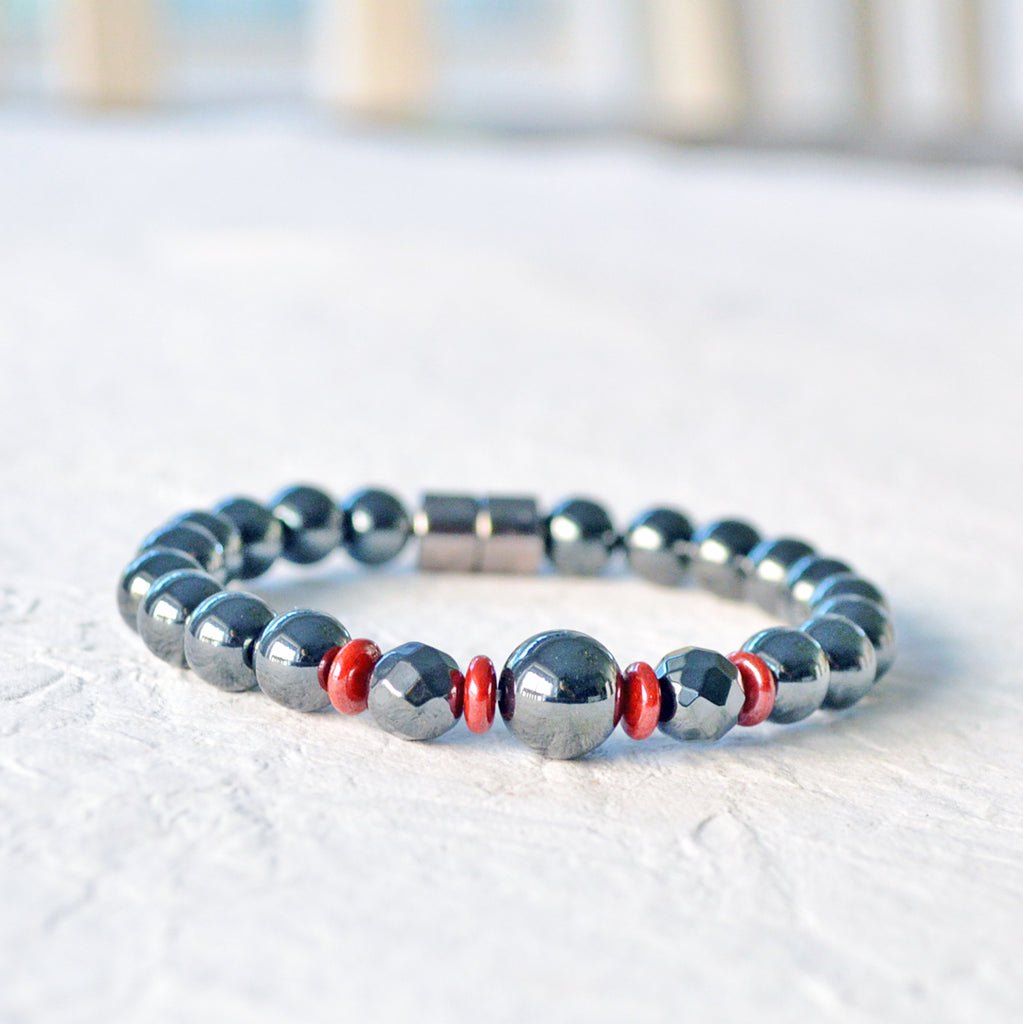 Magnetic bracelet handcrafted with powerful black hematite magnetic beads and accented with red czech glass beads. Bracelet secured with a strong magnetic clasp.
