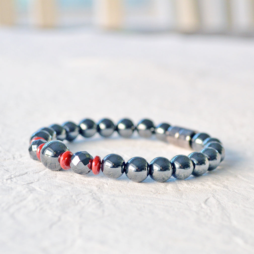 Magnetic bracelet handcrafted with powerful black hematite magnetic beads and accented with red czech glass beads. Bracelet secured with a strong magnetic clasp.