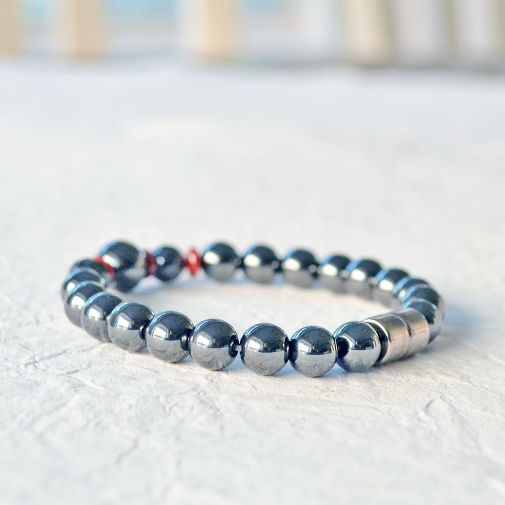 Magnetic bracelet handcrafted with powerful black hematite magnetic beads and accented with red czech glass beads. Bracelet secured with a strong magnetic clasp.