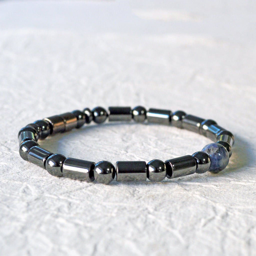 Magnetic therapy bracelet handcrafted with black hematite magnetic beads with a single sodalite gemstone bead in the center. Secured with a strong and easy-to-use magnetic clasp.