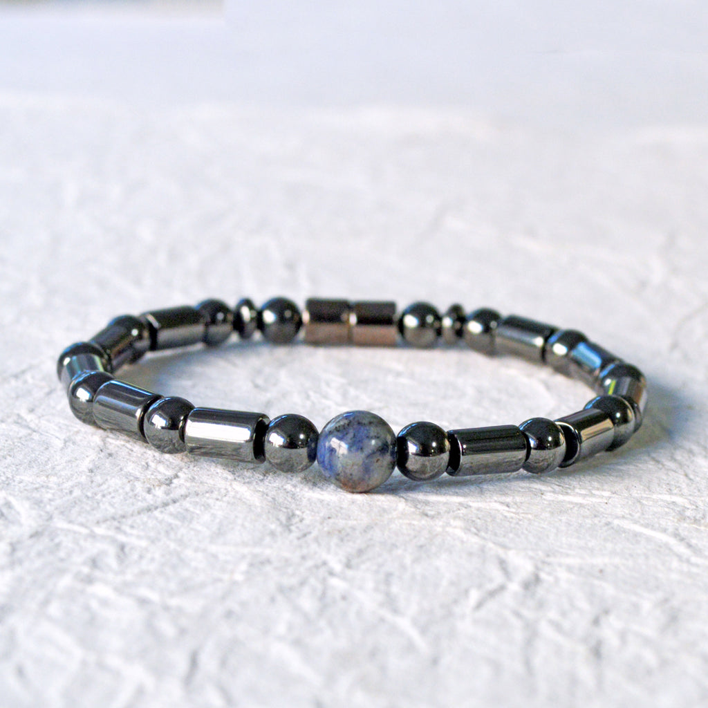 Magnetic therapy bracelet handcrafted with black hematite magnetic beads with a single sodalite gemstone bead in the center. Secured with a strong and easy-to-use magnetic clasp.