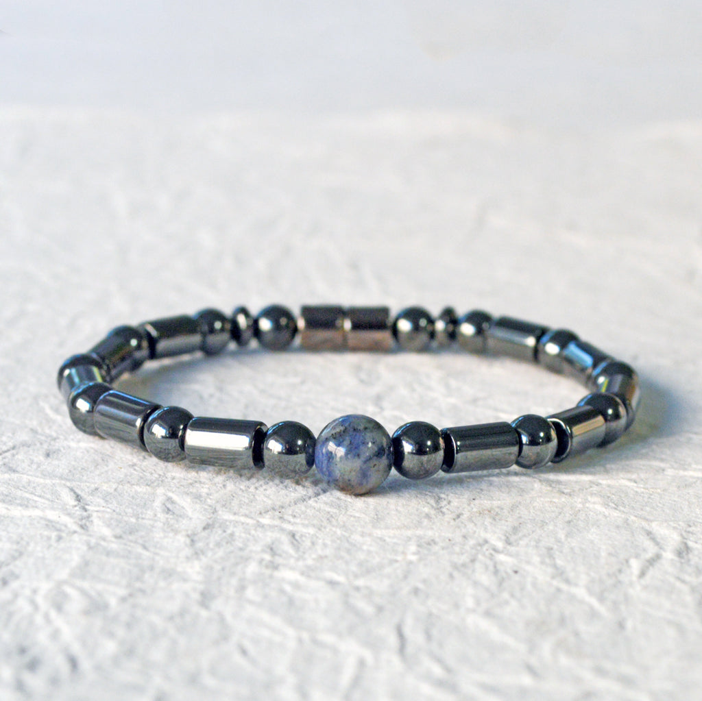 Magnetic therapy bracelet handcrafted with black hematite magnetic beads with a single sodalite gemstone bead in the center. Secured with a strong and easy-to-use magnetic clasp.