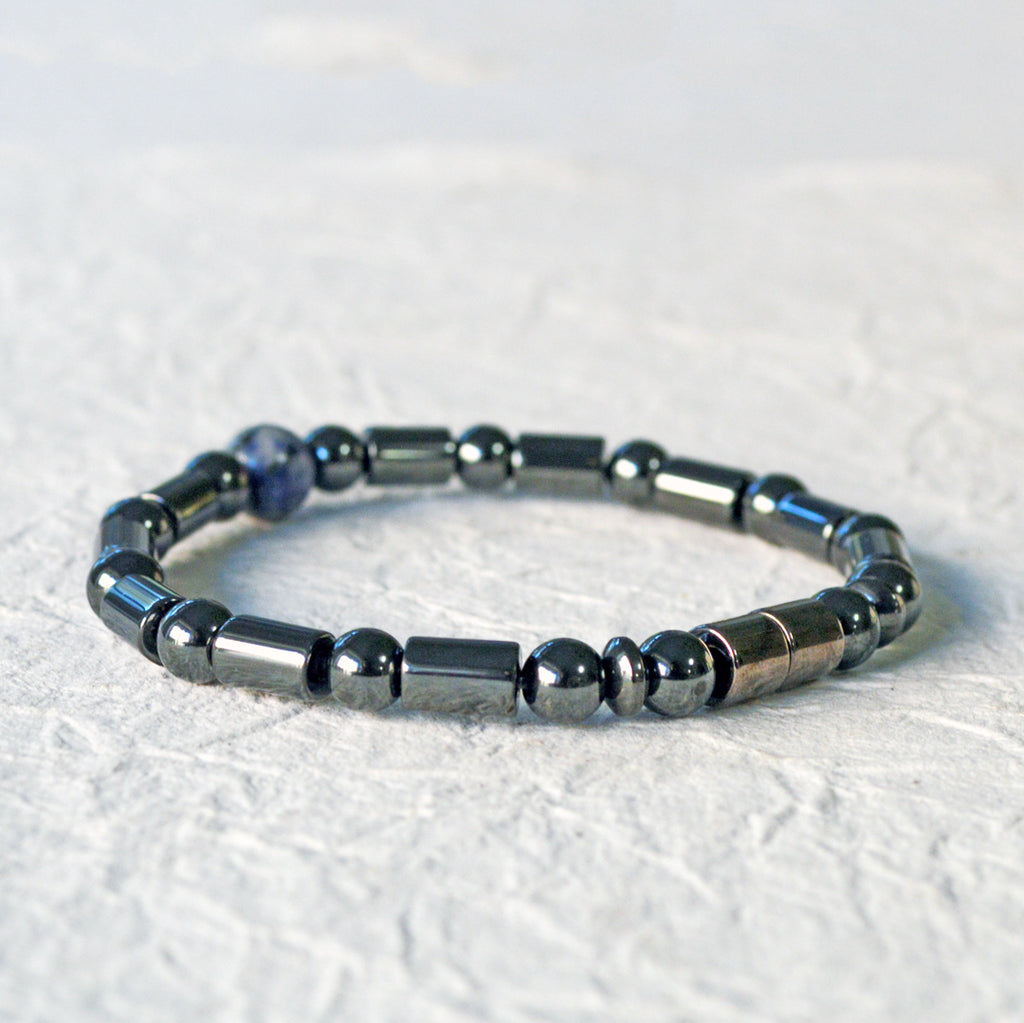 Magnetic therapy bracelet handcrafted with black hematite magnetic beads with a single sodalite gemstone bead in the center. Secured with a strong and easy-to-use magnetic clasp.