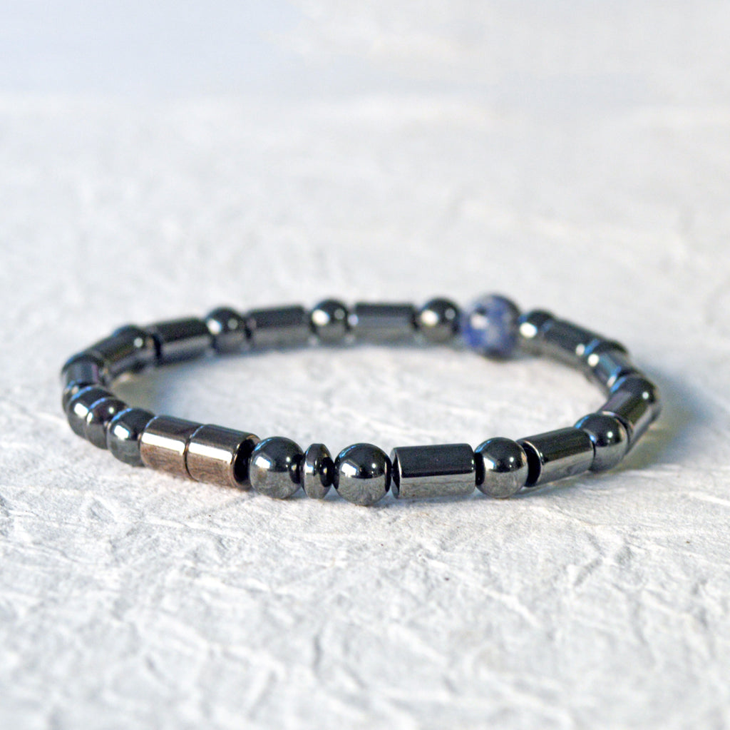 Magnetic therapy bracelet handcrafted with black hematite magnetic beads with a single sodalite gemstone bead in the center. Secured with a strong and easy-to-use magnetic clasp.