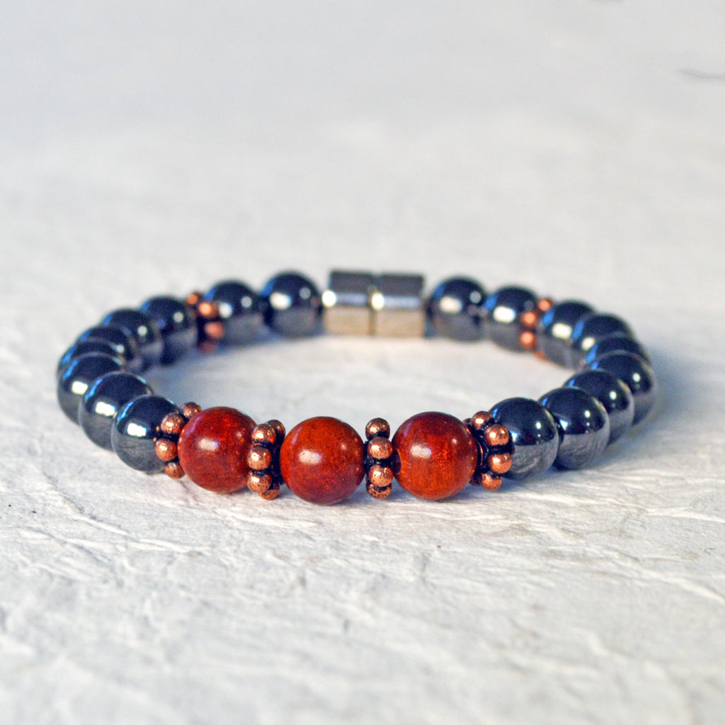 Hematite magnetic bracelet handcrafted with black high power magnetic beads. Raja Kayu wood beads are placed in the center surrounded by antique copper spacer beads.