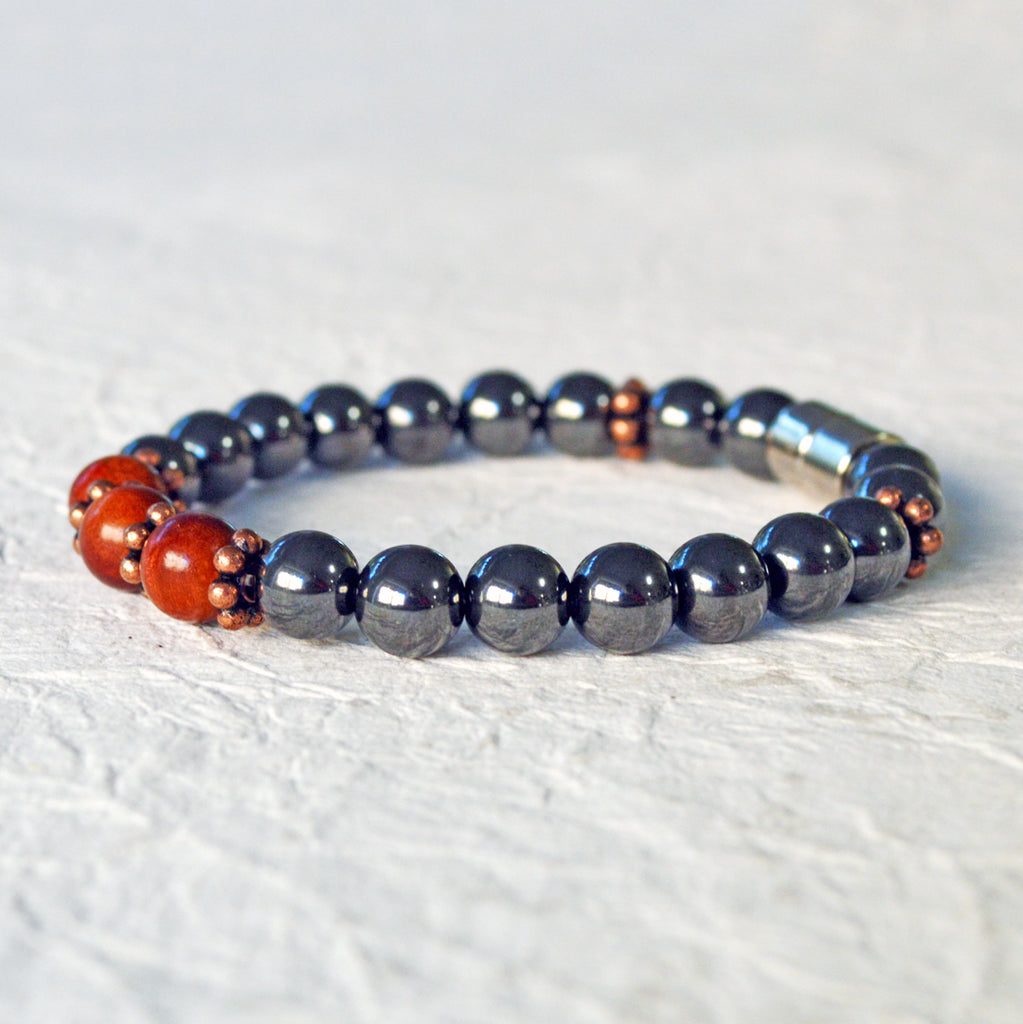 Hematite magnetic bracelet handcrafted with black high power magnetic beads. Raja Kayu wood beads are placed in the center surrounded by antique copper spacer beads.