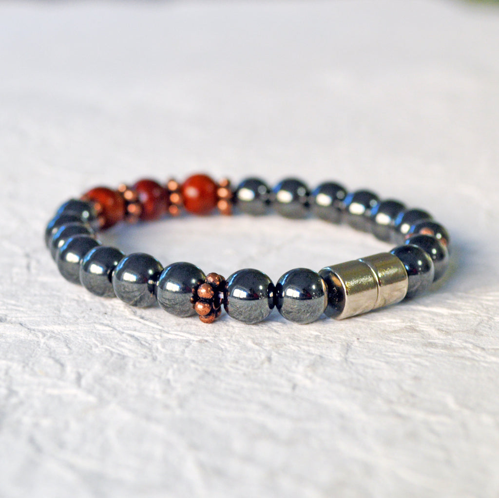 Hematite magnetic bracelet handcrafted with black high power magnetic beads. Raja Kayu wood beads are placed in the center surrounded by antique copper spacer beads.