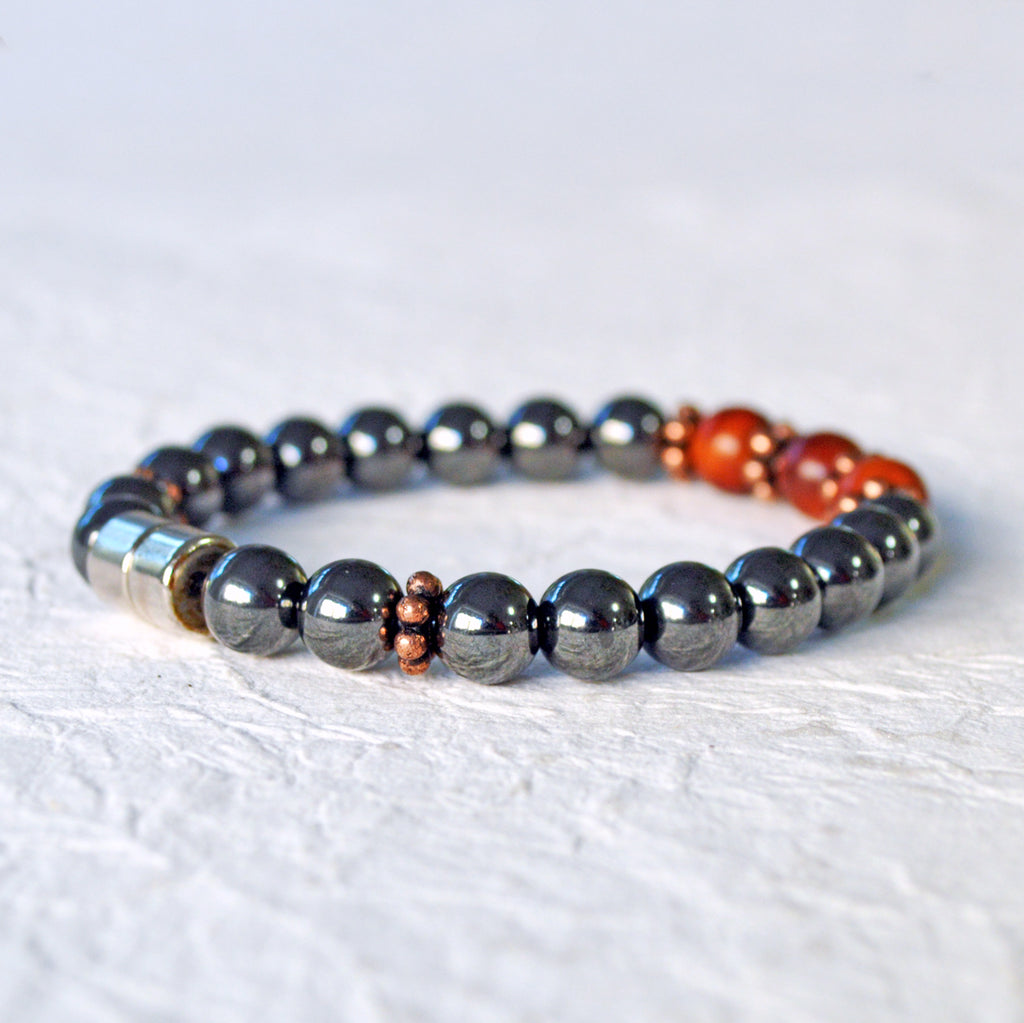 Hematite magnetic bracelet handcrafted with black high power magnetic beads. Raja Kayu wood beads are placed in the center surrounded by antique copper spacer beads.