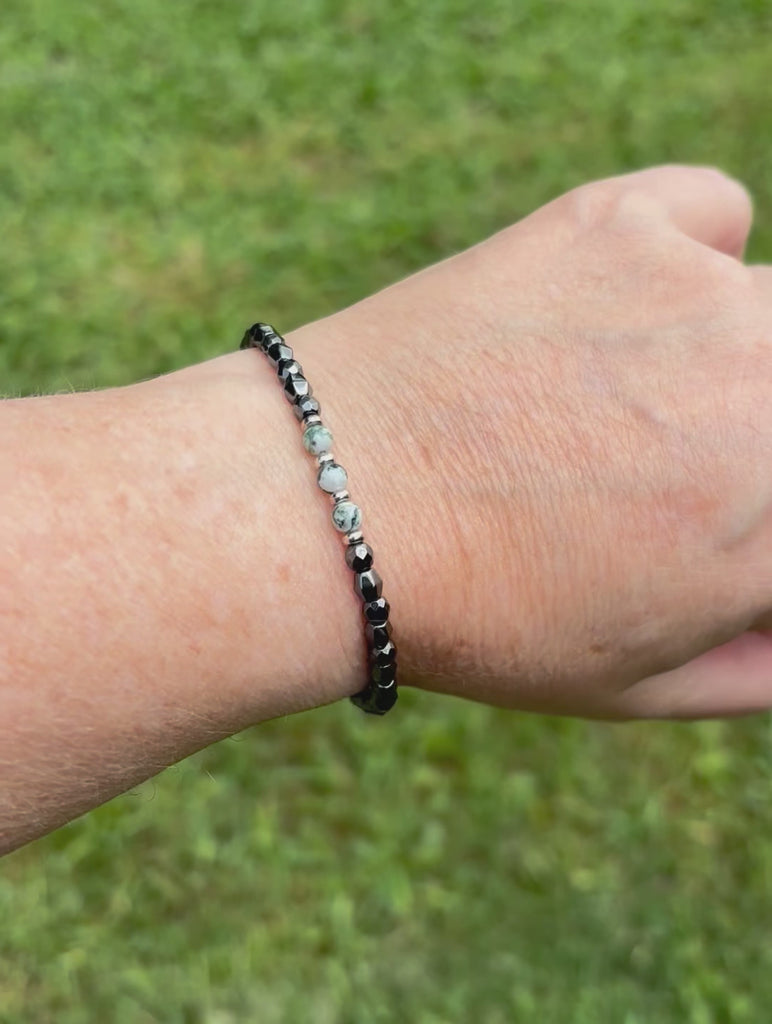 Magnetic therapy bracelet handcrafted with black hematite magnetic beads. In the center are three tree agate gemstone beads surrounded by antique silver spacer beads. The bracelet is secured with a strong magnetic clasp.