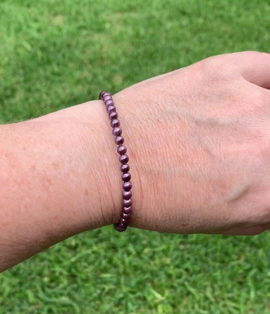 Burgundy magnetic bracelet handcrafted with pearl hematite magnetic beads and secured with a strong and easy-to-use magnetic clasp.
