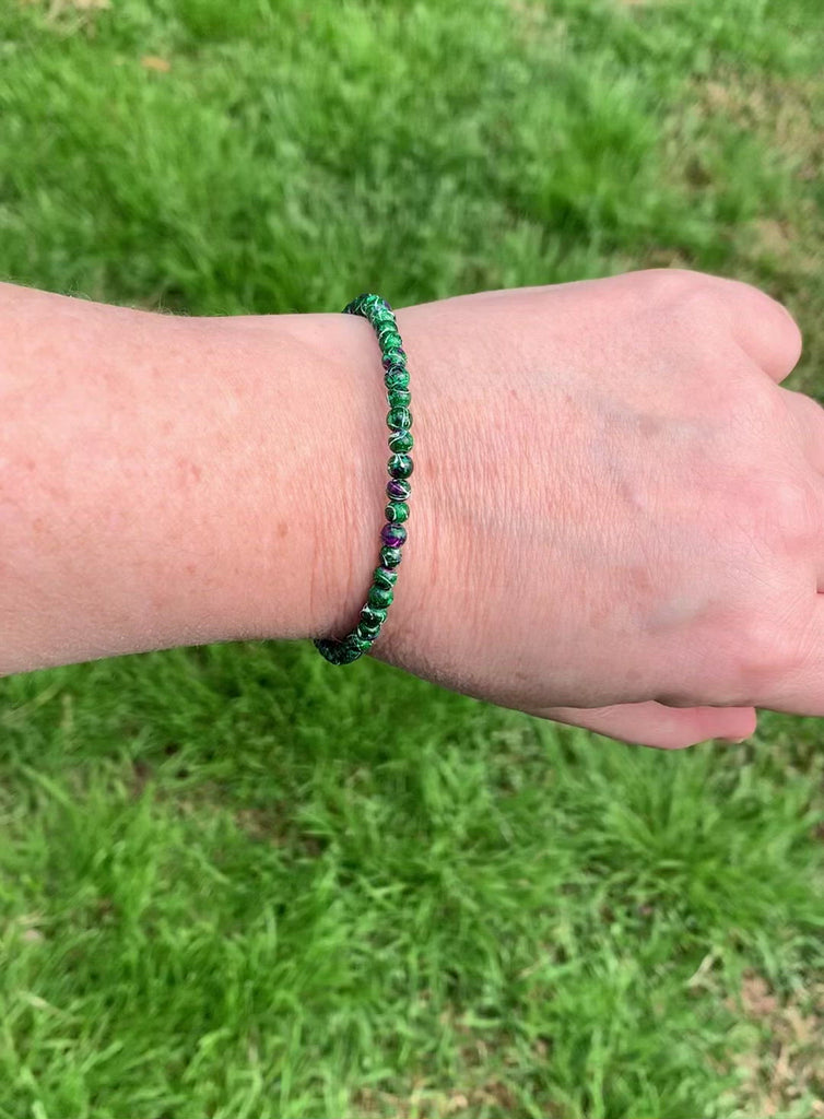 Magnetic bracelet is handcrafted with green picasso hematite magnetic beads. It is secured with a strong and easy-to-use magnetic clasp.
