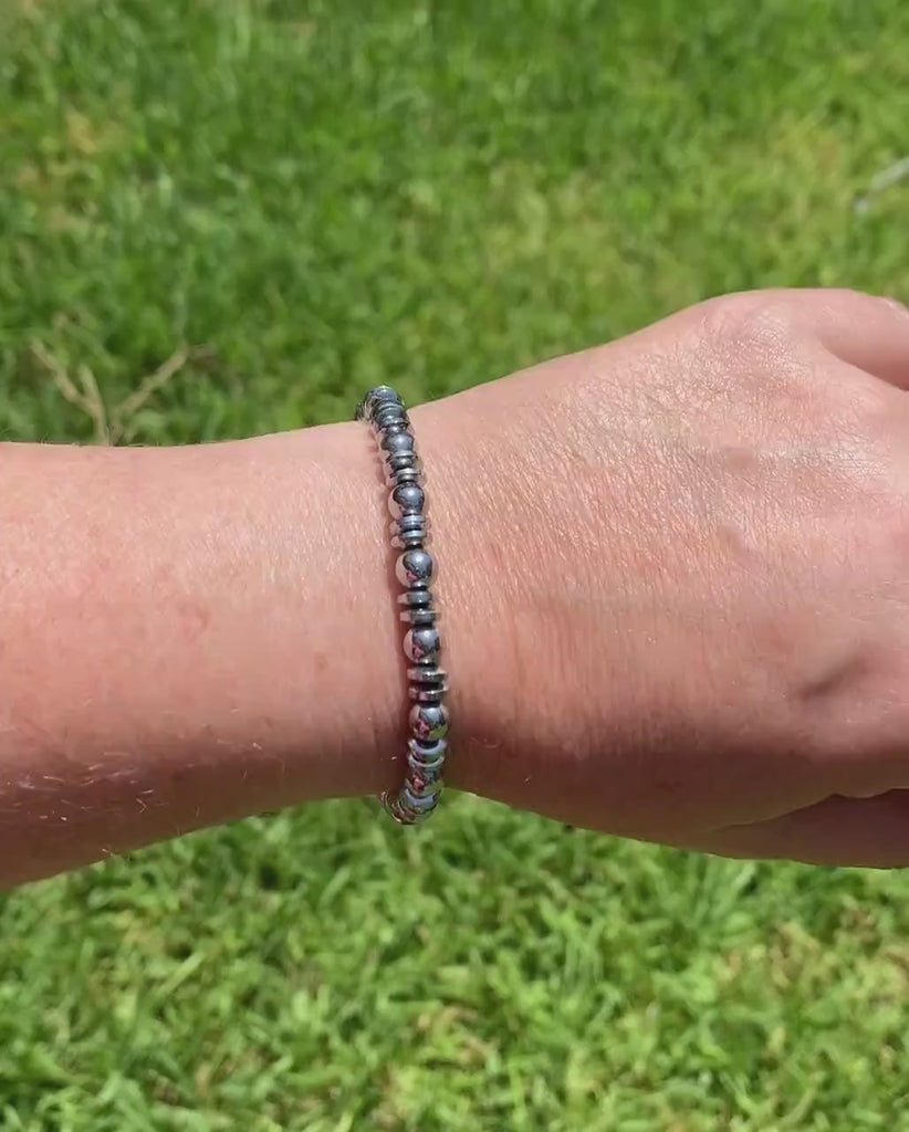 Silver magnetic bracelet handcrafted with silver metallic magnetic hematite beads. It is secured with a strong and easy-to-use magnetic clasp.